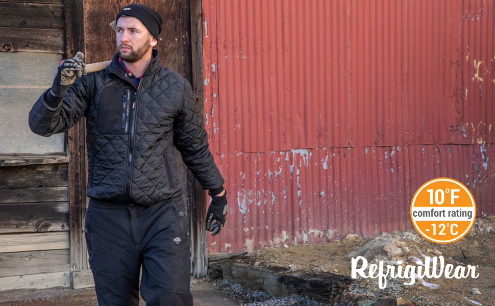 Man outside barn in the cold weather wearing a Diamond Quilted puffer jacket