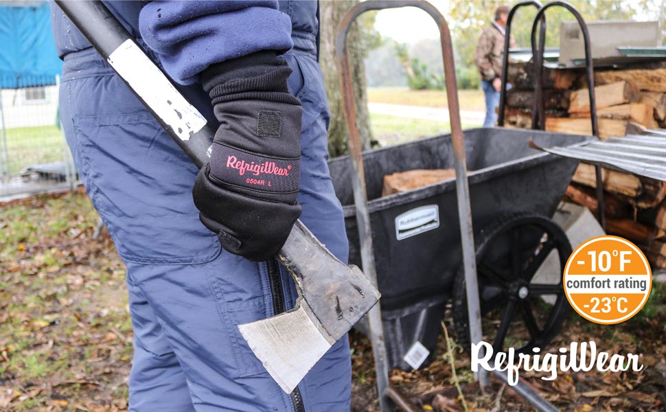 Man holding axe outside in the cold wearing the convertible softshell mitt