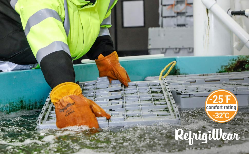 Person reaching into cold water wearing the Dipped Leather Mitts